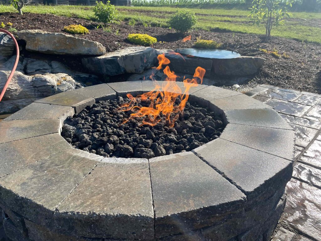 Fire pit with custom hardscape seating area in Hummelstown backyard